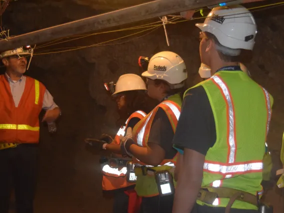 Students with mining gear inside of a mine