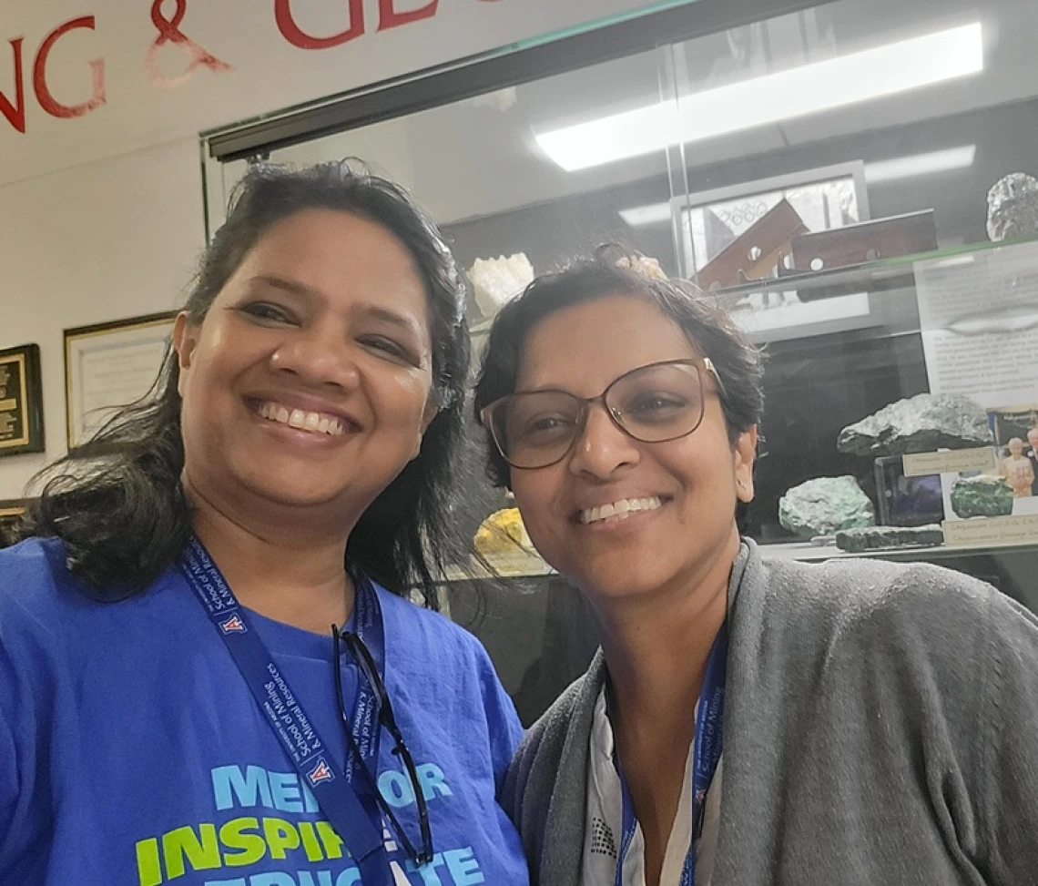 smiling teachers in front of gemstones